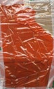 Abstract background. Fragment of brown cardboard transport packaging plastered with colored duct tape and polyethylene.