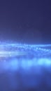 Abstract background of glowing blue particles forming a soft horizon line against a deep blue gradient Royalty Free Stock Photo