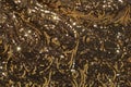 Abstract background of gold sequins dark shade