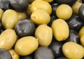 Abstract background: green and black whole olives.