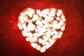 Abstract background of a heart made of blurred lights on red background with sparkles. Strong bokeh effect Royalty Free Stock Photo