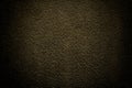 Abstract background of intense black gold orange felt material with vignette. Structure of black texture, velvet fabric Royalty Free Stock Photo