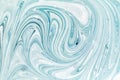 Abstract background for layouts. Stirring light turquoise and white paint close-up.