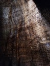 Abstract background. Light passes through the rough fabric. Sacking, rays of light, gloomy mood.