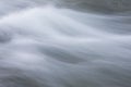 Abstract background from long exposure of water stream in a mountain river close-up Royalty Free Stock Photo
