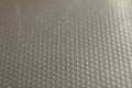 Abstract background of lots of grey pimples dots. Plastic surface with pimples