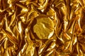 Golden wavy abstract background from a luxurious fabric, wavy folds, in the center a place for your gift in the form of