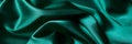 Abstract green background luxury cloth or liquid wave or wavy folds of grunge silk texture satin material. Royalty Free Stock Photo