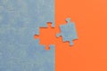 Abstract background of many puzzles on an orange background. The concept of teamwork