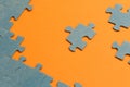 Abstract background of many puzzles on an orange background. The concept of teamwork