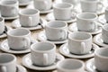 A lot of rows of pure white cups with plates for coffee or tea break Royalty Free Stock Photo