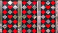Abstract background of metal rhombuses and red hearts