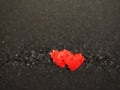 Abstract background mosaic made of red heart on black paper.