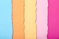 Abstract background of multi-colored stripes of torn cardboard lying vertically, top view Royalty Free Stock Photo