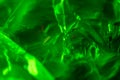 abstract background. neon green. macro photo of crumpled plastic bag with green light.