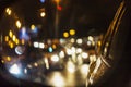 Abstract background of night city traffic jam with car lights through car mirror. Royalty Free Stock Photo