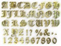 abstract background numbers and gothic font alphabet with golden metal effect Royalty Free Stock Photo