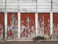 Abstract background of old facade with white and red wood sheets with peeling paint and wall with cracks. Concrete Wall Painted Royalty Free Stock Photo