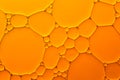 Abstract background of orange oil drops on water Royalty Free Stock Photo