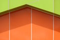 Abstract background pattern of vibrant green and orange aluminum composite tiles wall outside of modern building Royalty Free Stock Photo