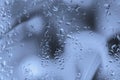 Abstract background with raindrops on wet glass. Blurred style, selective focus, soft blue grey color Royalty Free Stock Photo