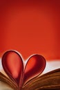 Abstract background with red accent. Old book. An open book with a heart folded from folded sheets. Love education concept.Copy Royalty Free Stock Photo