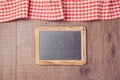 Abstract background with red checked tablecloth and chalkboard. View from above