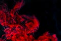 Abstract background, red smoke texture in the air. Smoke fragments isolated on dark background. Royalty Free Stock Photo