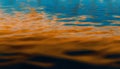 abstract background of rippled water surface with orange and blue colors Royalty Free Stock Photo