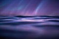 Close-up of rippling water surface reflecting soft purple and blue light, creating an abstract Royalty Free Stock Photo