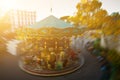 Abstract background. Rotating classic style carousel on Montmartre in backlit evening sunset sunbeam . Motion blur effect