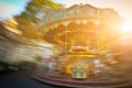 Abstract background. Rotating classic style carousel on Montmartre in backlit evening sunset sunbeam . Motion blur effect