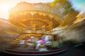 Abstract background. Rotating classic style carousel on Montmartre in backlit evening sunset sunbeam . Motion blur effect