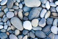 Abstract background with round pebble stones. Stones beach smooth. Top view. Sea, summer