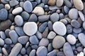 Abstract background with round pebble stones. Stones beach smooth. Top view. Summer day. Close-up. Flat lay texture in daylight Royalty Free Stock Photo