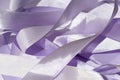 Abstract background of satin purple ribbons.