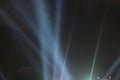 Searchlights shining beams of light into the black sky. Royalty Free Stock Photo