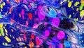 abstract background of shiny glossy surface like wavy blue liquid with rainbow color circles like drops of paint in oil Royalty Free Stock Photo