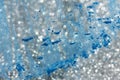 Abstract background with silver defocused glitter effect and blue powder on glass