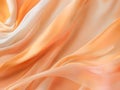 Abstract background of smooth flowing silk with soft wave of pastel orange, peach, & custard colors Royalty Free Stock Photo