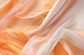 Abstract background of smooth flowing silk with soft wave of pastel orange, peach, & custard colors Royalty Free Stock Photo