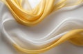 Abstract background of smooth flowing silk with yellow & white colors