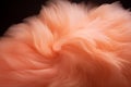 abstract background of soft pink fur on a black background close up. Peach fuzz color of 2024