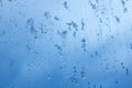 Abstract background, streams of rain and snow on the glass on the background against the blue of a stormy sky Royalty Free Stock Photo