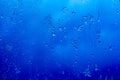 Abstract background, streams of rain and snow on the glass on the background against the blue of a stormy sky Royalty Free Stock Photo