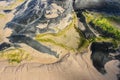 Almost abstract background of swirls of string algae and sand and rock at the oceans edge - top view