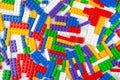 Abstract background texture of colored constructor blocks. Background of colorful plastic part of constructor. Pile of colored toy