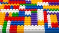 Abstract background texture of colored constructor blocks. Background of colorful plastic part of constructor. Pile of colored toy