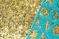 abstract background and texture of gold material with large glitter and shiny blue material with carved letters on top. Royalty Free Stock Photo