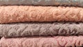 Abstract background and texture from a stack of colored soft terry towels. Lots of colorful bath towels stacked on each Royalty Free Stock Photo